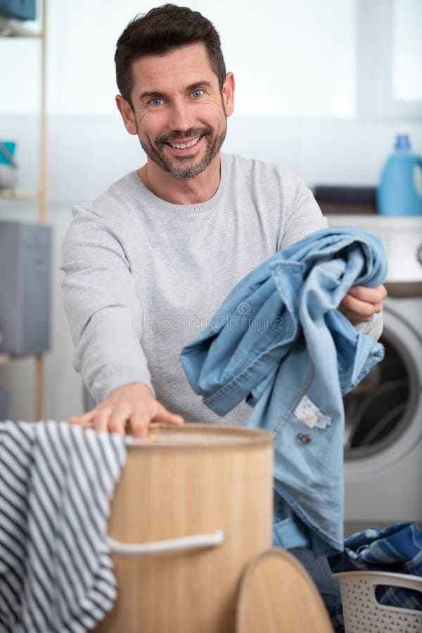 Smiling Man Sorting Out Laundry Stock Photo Image of dryer, caucasian