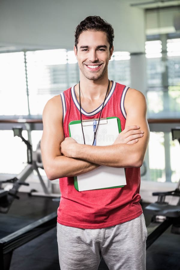 Smiling man standing with clipboard and stopwatch royalty free stock images Smiling man standing with clipboard and stopwatch royalty free stock images
