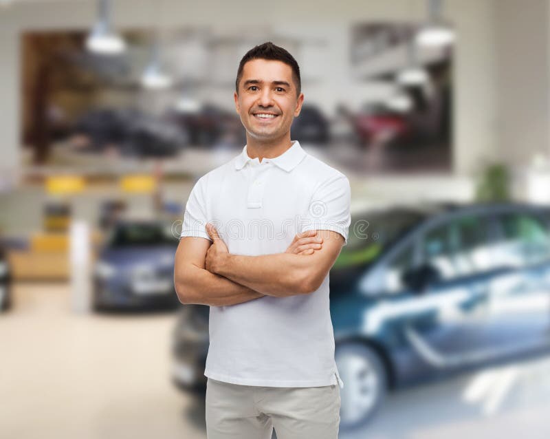 Smiling man in white t-shirt over auto salon