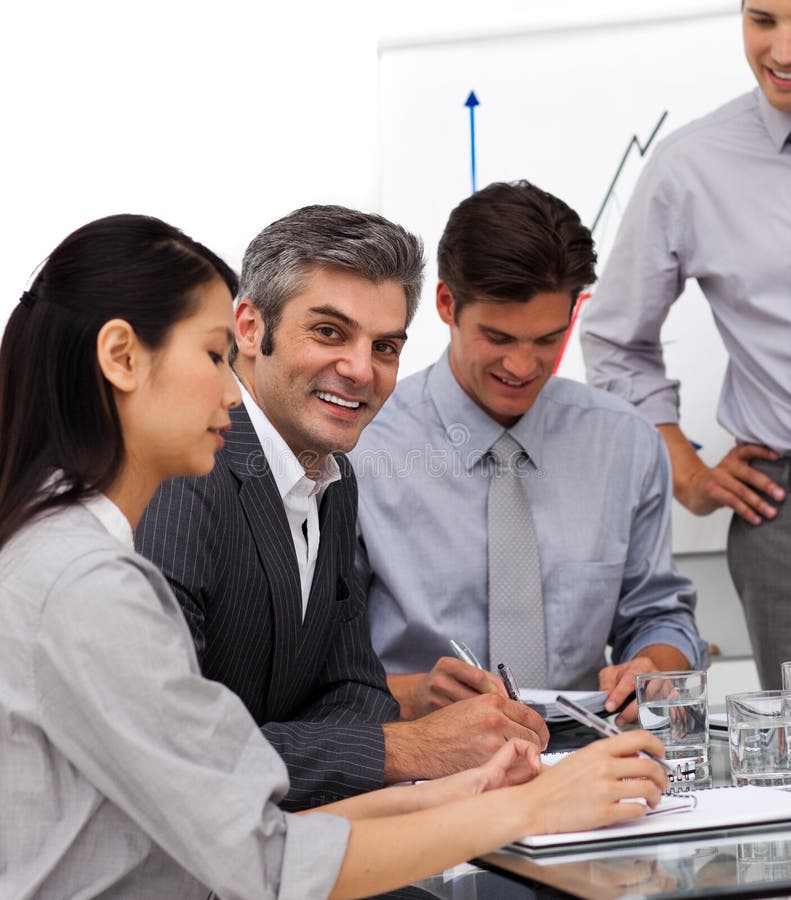 Smiling mature manager in a meeting with his team royalty free stock image