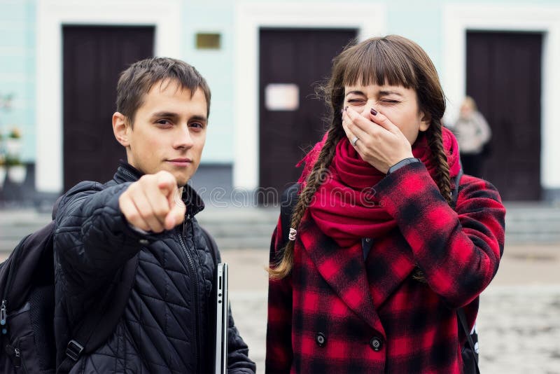 Man pointing his finger to you while girl yawns royalty free stock images Man pointing his finger to you while girl yawns royalty free stock images