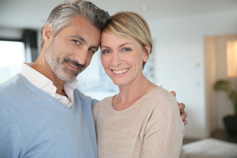 Smiling middle-aged couple at home stock photo Smiling middle-aged couple at home stock photo