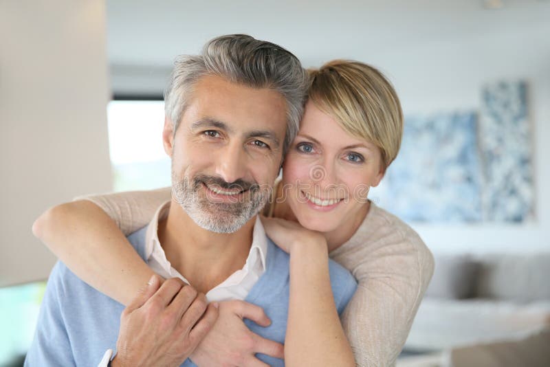 Smiling middle-aged couple at home