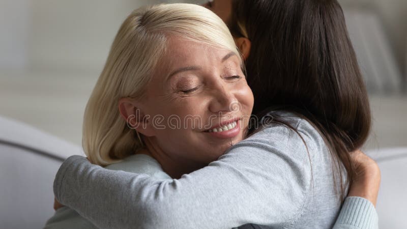 Smiling middle-aged mom and adult daughter hug royalty free stock image Smiling middle-aged mom and adult daughter hug royalty free stock image