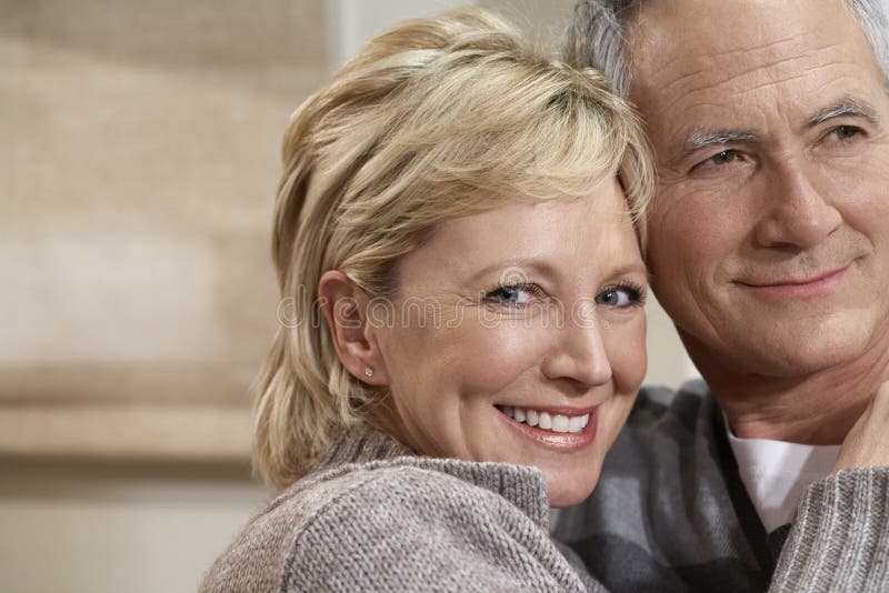 Smiling Middle Aged Woman Embracing Man
