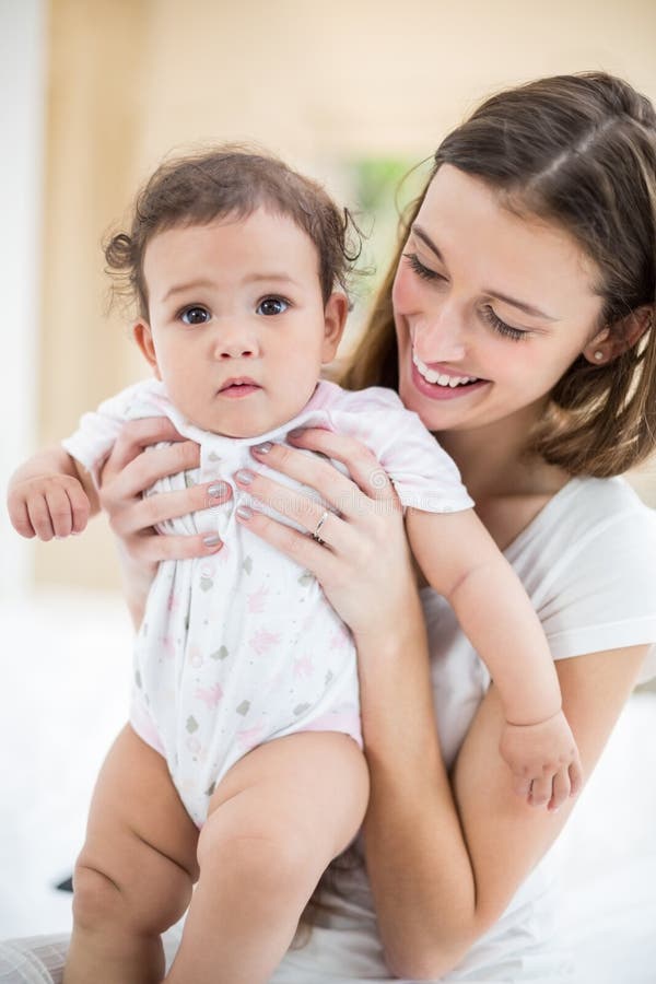 Smiling Mother Holding Cute Baby Stock Photo - Image of bonding, front