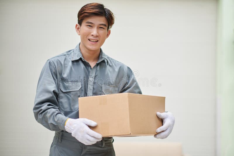 Smiling Mover Holding Box royalty free stock image
