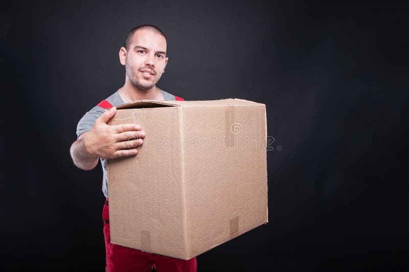 Smiling mover man holding big cardboard box royalty free stock image