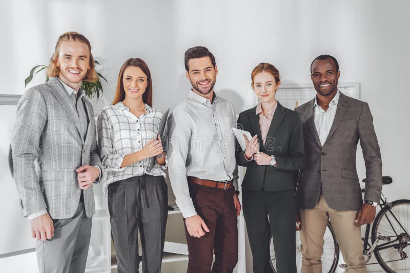 smiling multicultural businesspeople standing and looking stock photography smiling multicultural businesspeople standing and looking stock photography