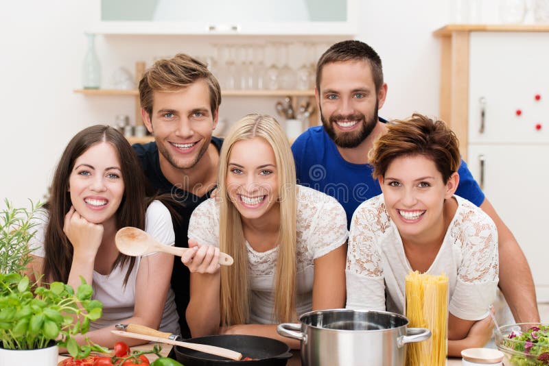 Smiling multicultural group of friends cooking royalty free stock photo Smiling multicultural group of friends cooking royalty free stock photo