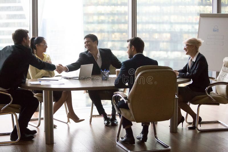 Smiling multiracial business people sitting at meeting stock image Smiling multiracial business people sitting at meeting stock image