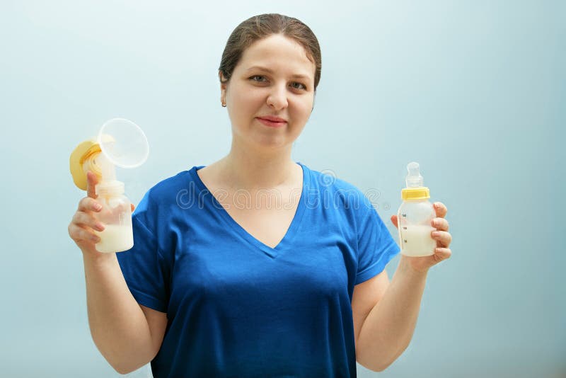 Smiling nurse is holding breast pump, bottle of milk. mixed feeding, preserving lactation of working mom. Help with breastfeeding, royalty free stock photos Smiling nurse is holding breast pump, bottle of milk. mixed feeding, preserving lactation of working mom. Help with breastfeeding, royalty free stock photos