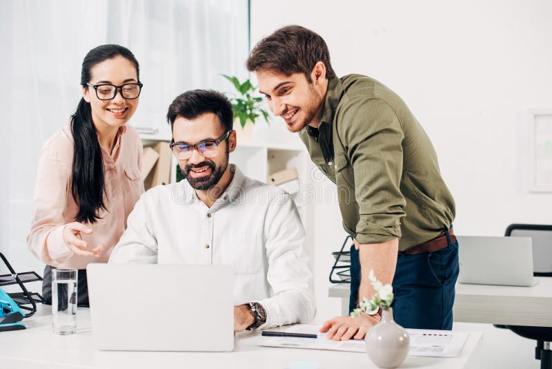 Smiling Office Managers Looking at Laptop Stock Image Image of communication, businesspeople