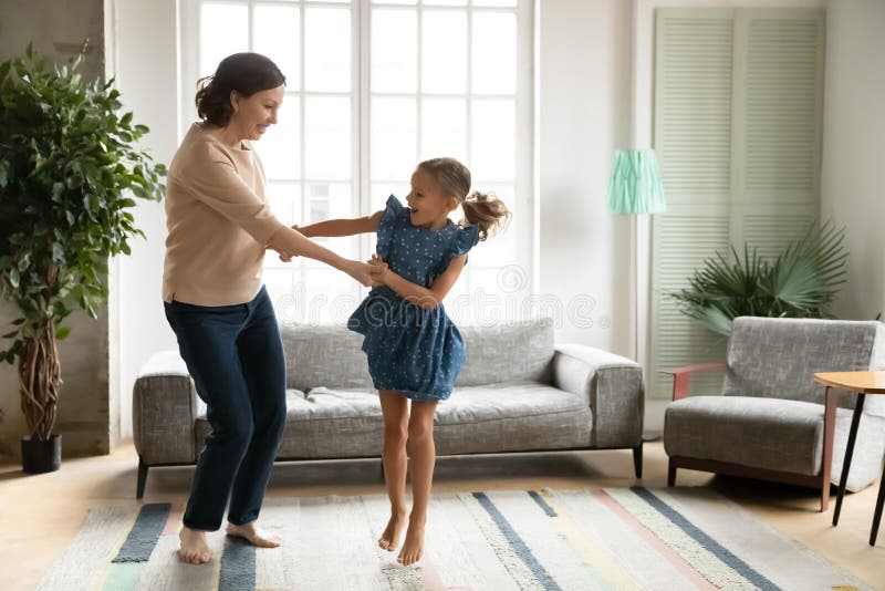 Happy Mature Grandmother And Granddaughter Having Fun Tickling On Couch Stock Image Image Of 