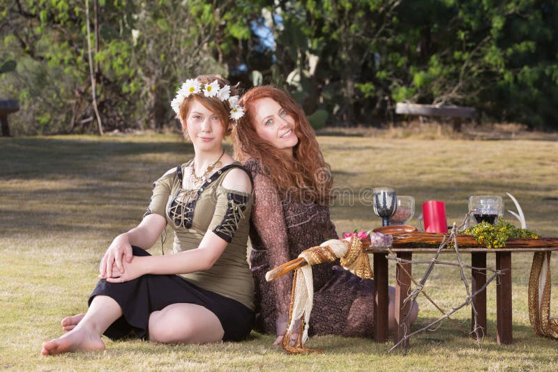 Two smiling pagan women at outdoor altar with pentagram. Two smiling pagan women at outdoor altar with pentagram