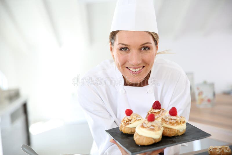 Smiling pastry chef with deserts