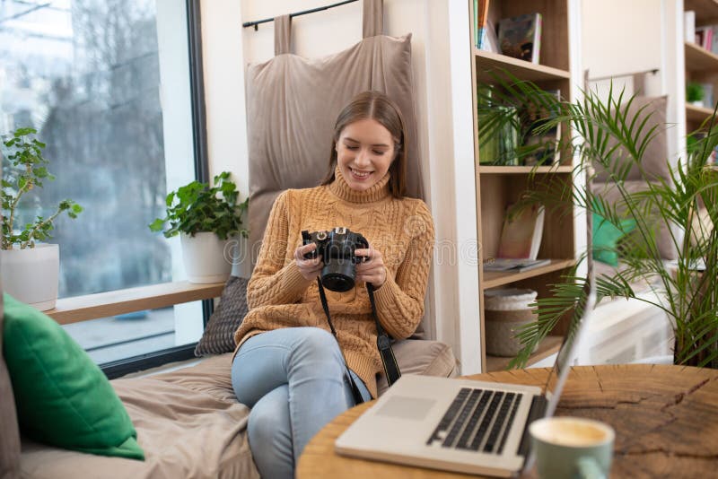 Smiling photographer editing her pictures in photoshop