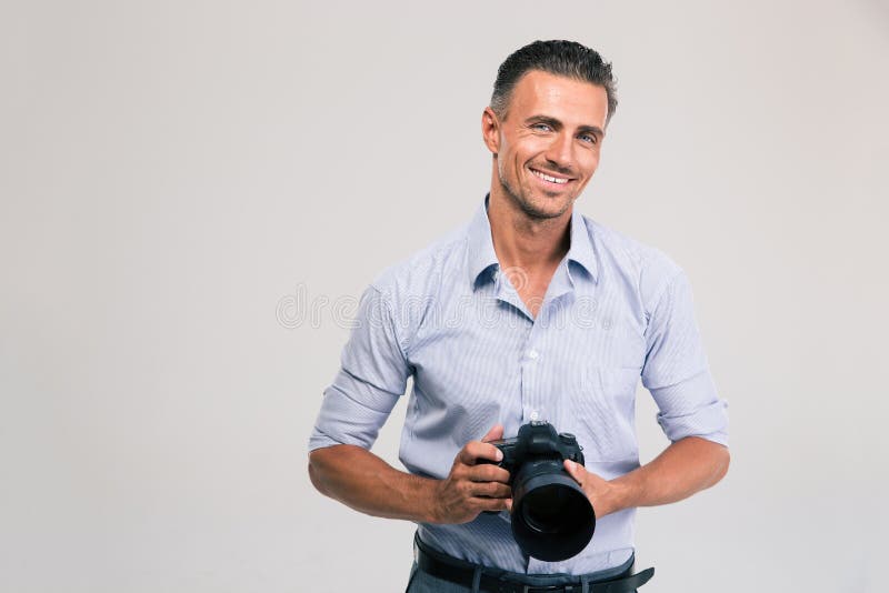 Smiling photographer holding camera