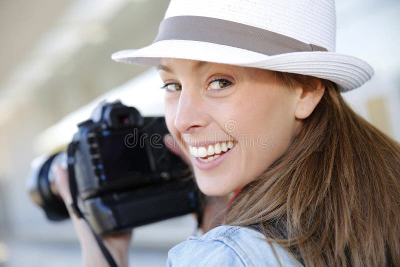 Smiling photographer with reflex camera