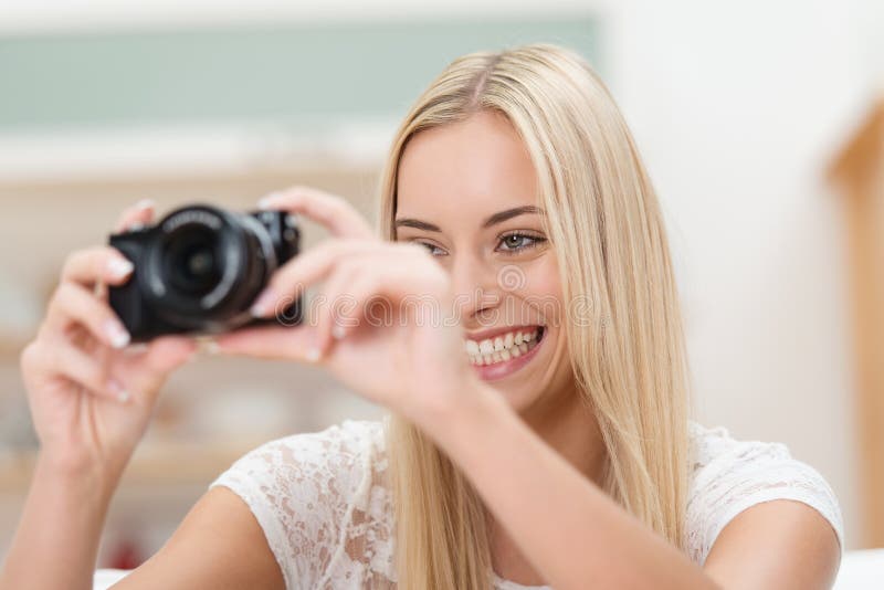 Smiling photographer taking a photograph