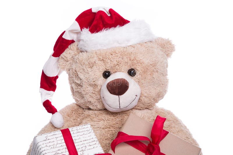 Smiling portrait teddy bear wearing Christmas hat with gift boxes on white background royalty free stock photography Smiling portrait teddy bear wearing Christmas hat with gift boxes on white background royalty free stock photography
