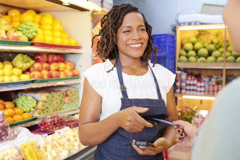 Grocery store worker accepting payment