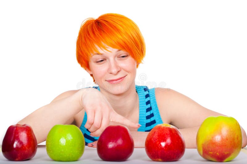 Smiling red hair woman choosing apple