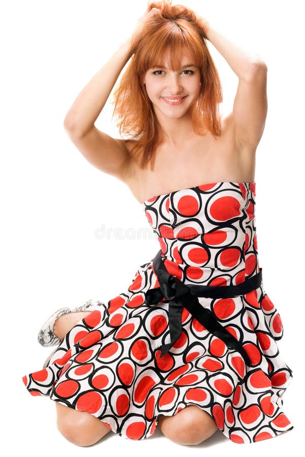 Smiling red-haired girl in a dress