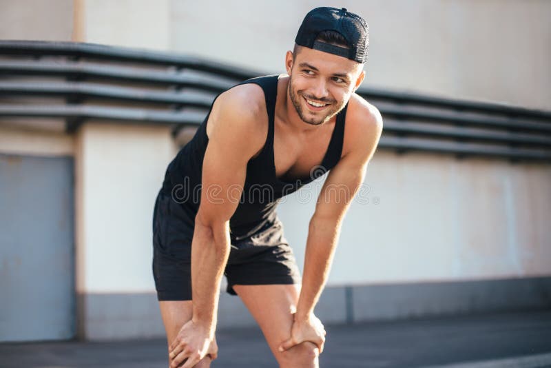 Smiling runner relaxing after workout