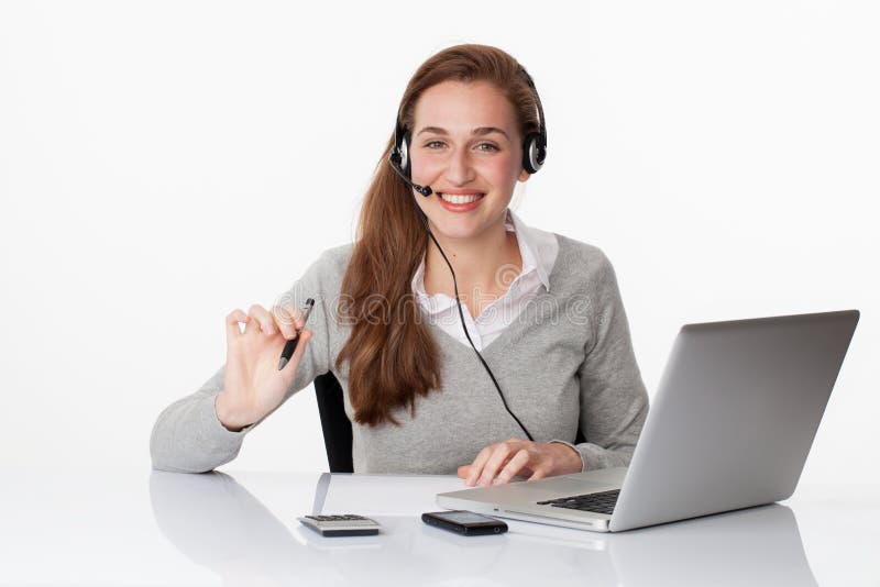 Smiling 20s professional with headset and computer in white office