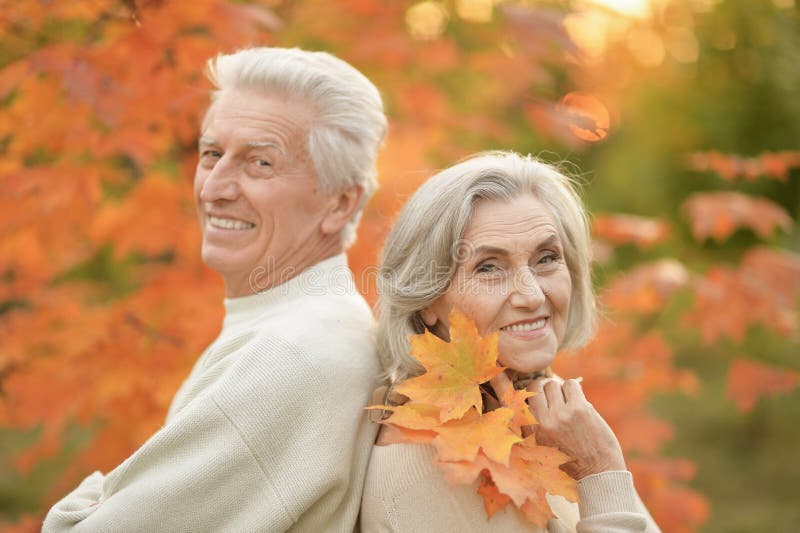 Smiling Senior Couple Embracing In Autumn Park Back To Back Stock Image Image Of Retire