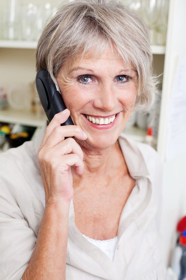Smiling senior lady talking on a telephone royalty free stock photo Smiling senior lady talking on a telephone royalty free stock photo