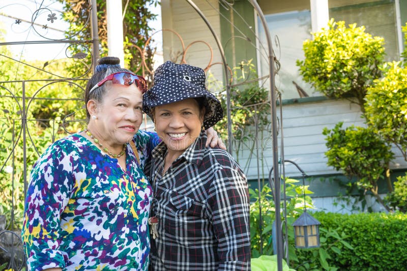 Smiling sisters in the garden stock image Smiling sisters in the garden stock image