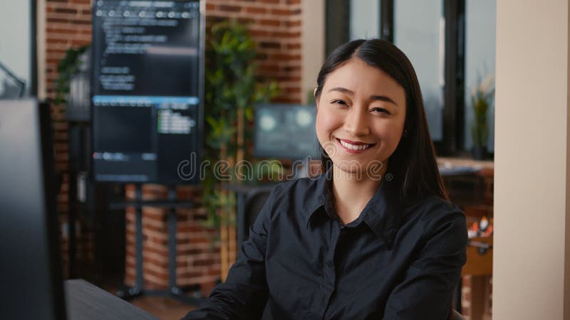 Smiling software developer typing machine learning app code on computer keyboard royalty free stock image