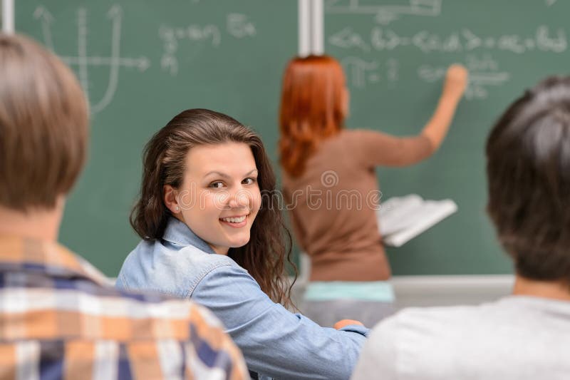 Smiling student girl sitting in math classroom royalty free stock images Smiling student girl sitting in math classroom royalty free stock images