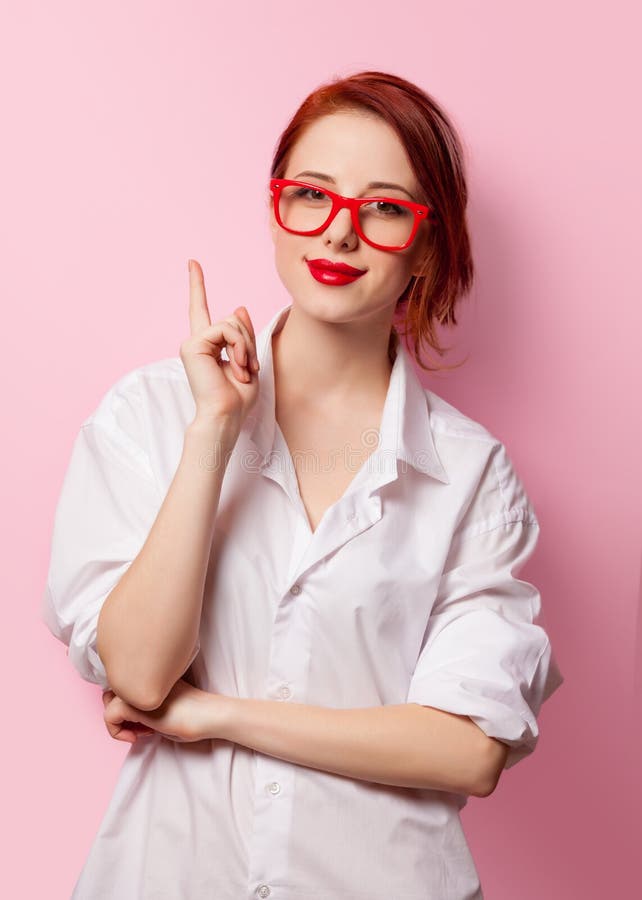 Smiling student girl in white shirt and red glasses