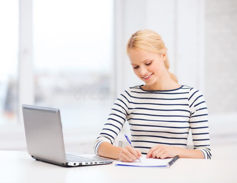 Smiling student with laptop computer and documents royalty free stock image
