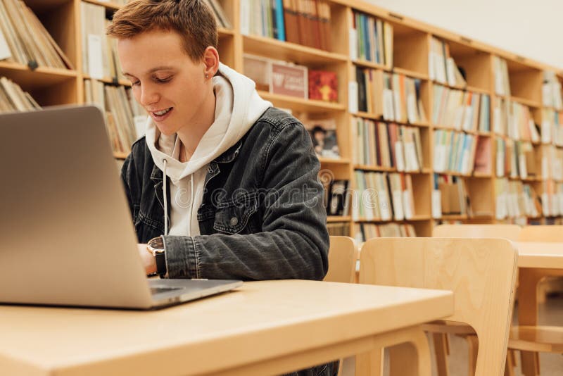 Smiling Student Preparing for Exams in College Library Stock Image
