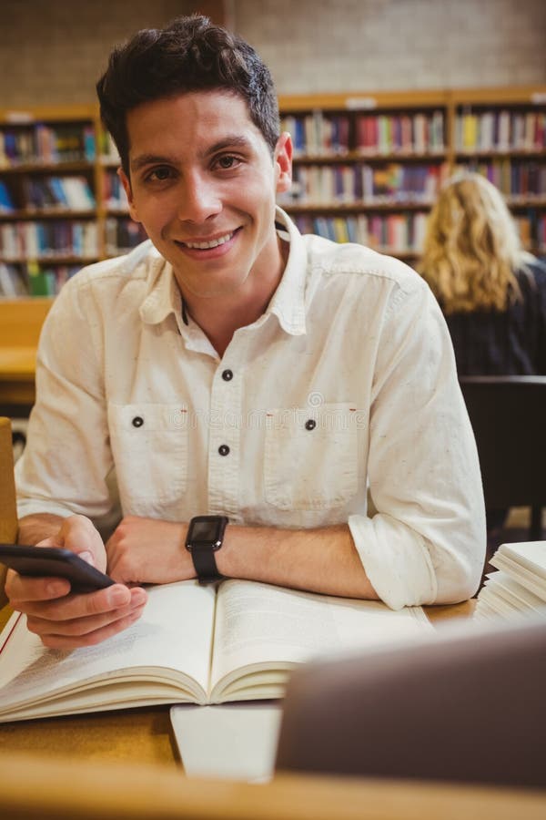 Smiling student using his smartphone stock images Smiling student using his smartphone stock images