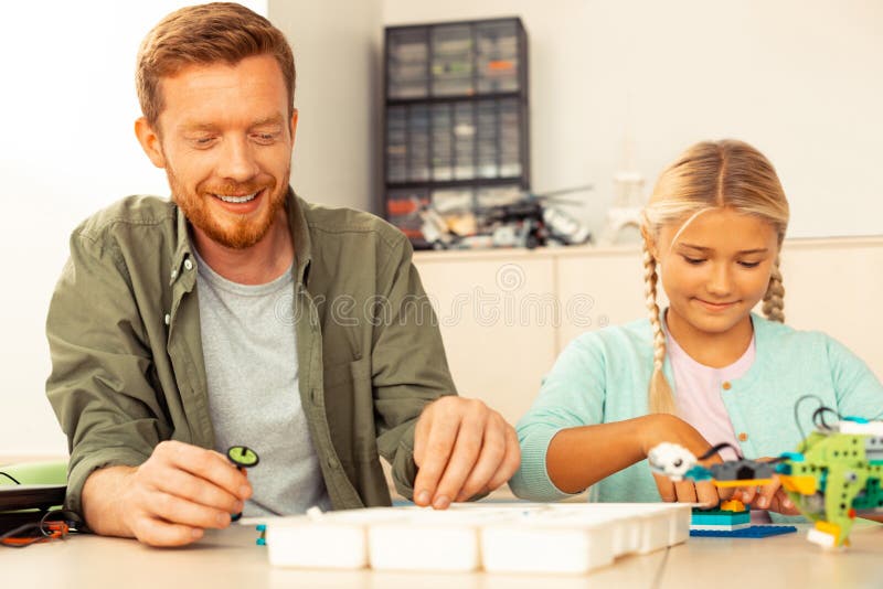 Smiling teacher feeling like a pupil again. royalty free stock image