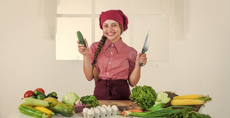 smiling teen girl in chef uniform cooking vegetables, vitamin