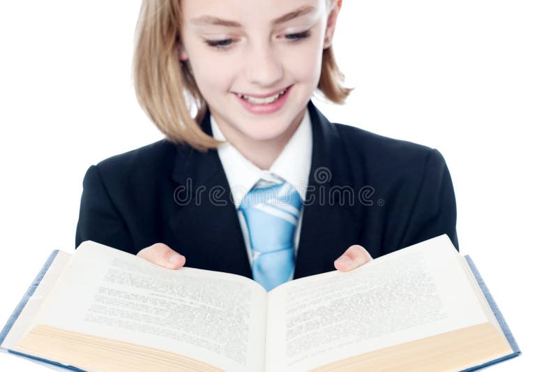 Smiling teen girl looking at a book royalty free stock photo Smiling teen girl looking at a book royalty free stock photo