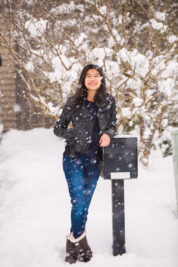 Smiling Teen Girl in Winter Snowfall Leaning Against Mailbox Stock ...