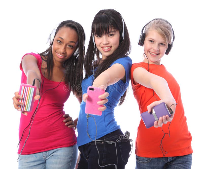 Smiling teenage girls fun with mobile phone music