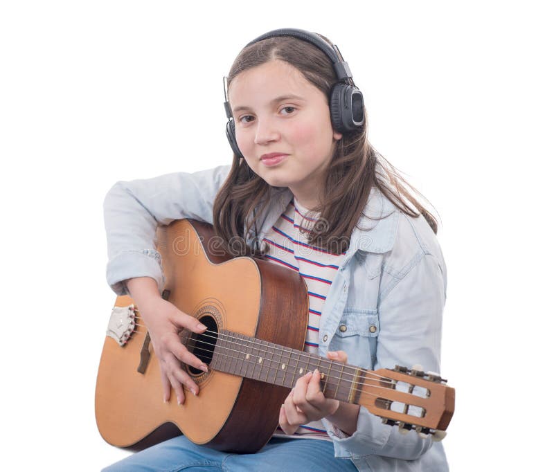 Smiling teenager girl playing acoustic guitar on white stock photography Smiling teenager girl playing acoustic guitar on white stock photography