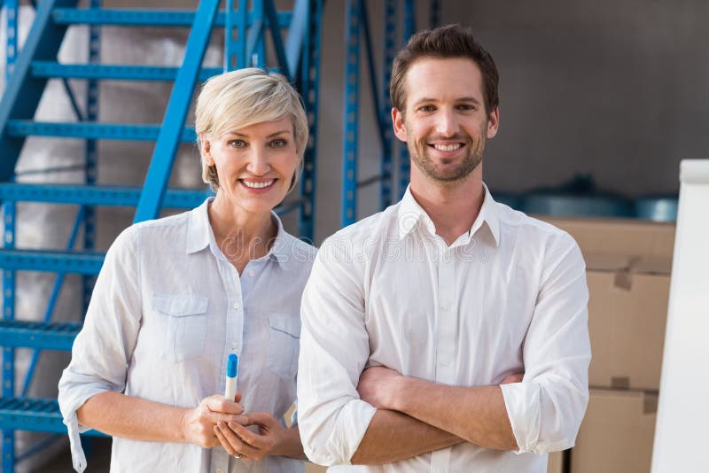 Smiling warehouse managers looking at camera royalty free stock images
