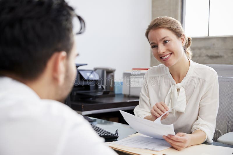 Smiling white female professional in meeting with young man