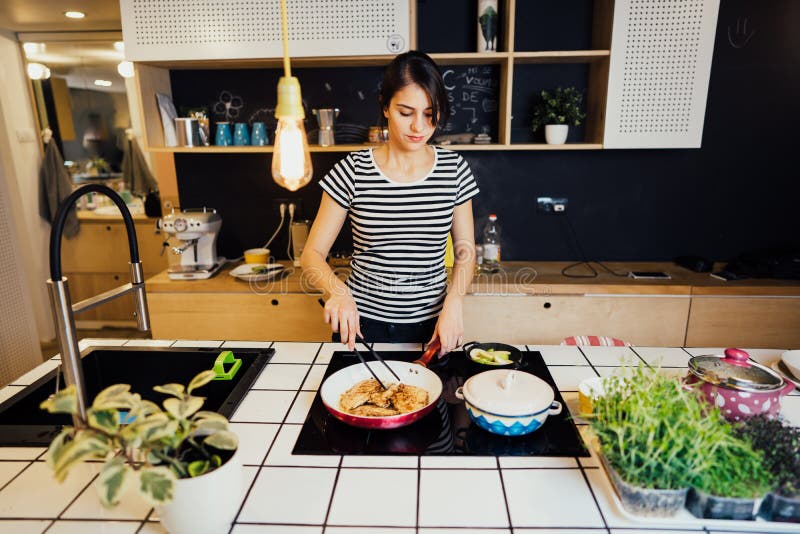 Smiling Woman Cooking a Healthy Meal in Home Kitchen.Making Dinner on
