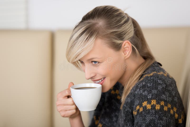 Smiling woman with a cup of coffee royalty free stock image