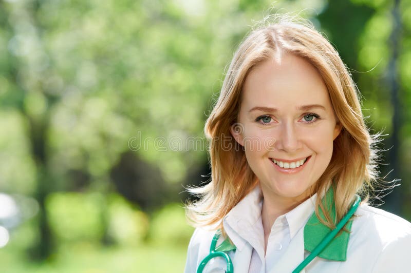 Smiling woman doctor outdoors
